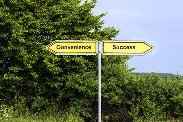Yellow road signs pointing in opposite directions with text Convenience, Success,  green bushes and a blue sky in the background, symbol concept