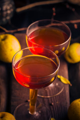 cup tincture wooden table fruits quince