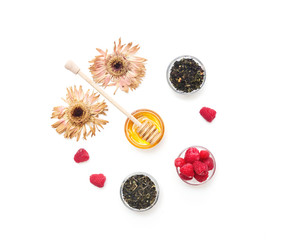 Herbal tea with honey, wild berry and flowers on white background. Flat lay, copy space