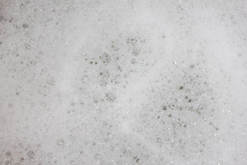 fluffy white head, plenty of bubbles. Foam in the tub closeup..