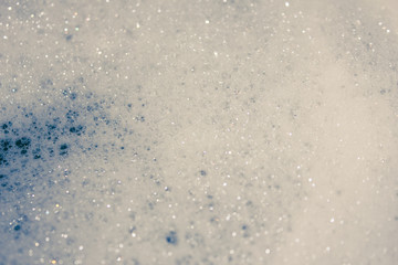 fluffy white head, plenty of bubbles. Foam in the tub closeup..
