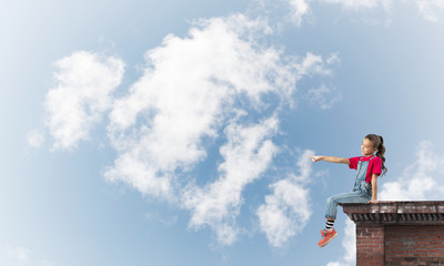 Concept of careless happy childhood with girl showing touch gesture