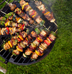 Grilled skewers on a grilled plate, outdoor, top view