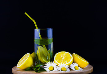 Fresh lemonade with lemon on wooden background