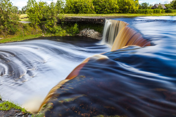 Jagala is the biggest waterfall in Estonia. Long exposure day shot. Close up. Water is red due to swamp organics.