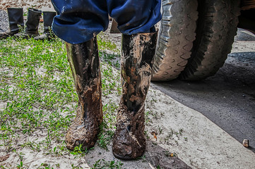 Fototapeta na wymiar A worker in dirty boots. Background blur.