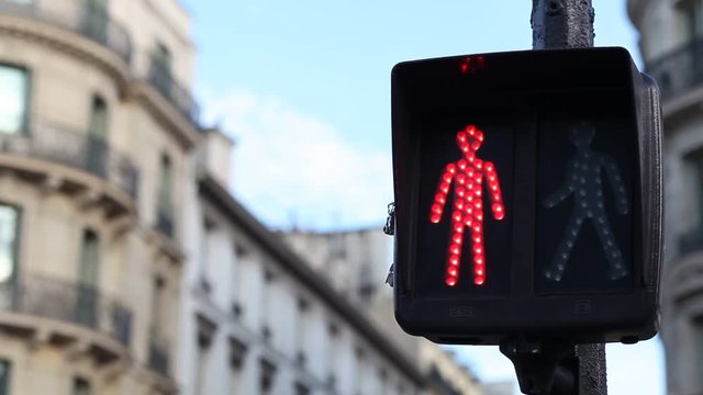 traffic light for pedestrians changing from red to green on the street