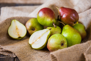 Pears on a wooden background and burlap