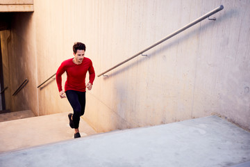 Hiit cardio workout on stairs. Young athlete doing interval exercises