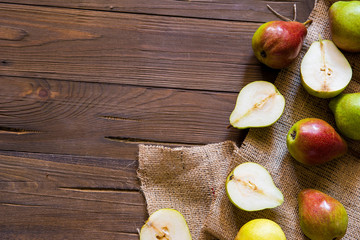 Pears on a wooden background and burlap