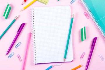 School stationery on pink background with copyspace