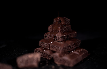 Dark chocolate on a black background