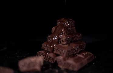 Dark chocolate on a black background
