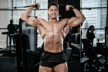 Fototapeta premium Strong bodybuilder man at the gym