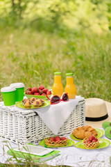 Summer time: picnic on the grass - coffee and croissants, juice and berries.