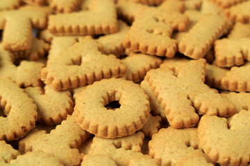 Close-up of the word OK spelled with alphabet shaped biscuits on heap of the same biscuits, with Selective Focus 