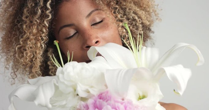 beauty mixed race woman in studio with flowers