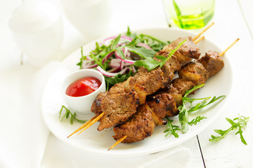 Beef shish kebab  on skewers in curry.