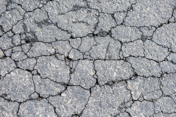 Cracked asphalt on road. Abstract background.