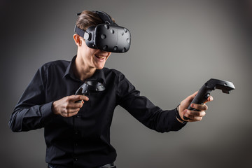 young man playing games with virtual reality goggles © alfa27