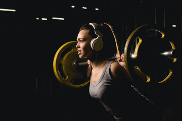 fitness, sport, powerlifting and people concept - sporty woman exercising with barbell in gym