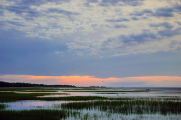 Sunset red over the Bay. Landscape of the marine in the evening. The nature of the sea in calm.