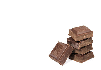 Stack of dark chocolate cubes isolated on white background, with free space for text and design 