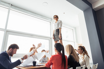 Group of business people supporting dancing female colleague