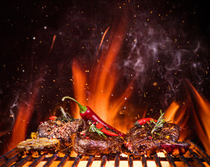 Beef steaks on the grill with flames
