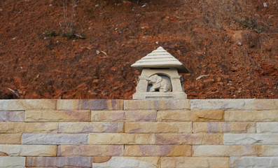 Fototapeta na wymiar Sculpture of an elephant on a brick wall