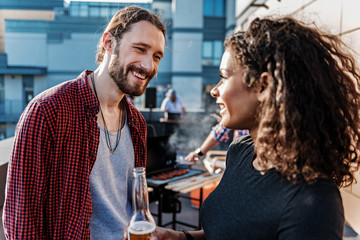 Happy couple enjoying communication on rooftop terrace