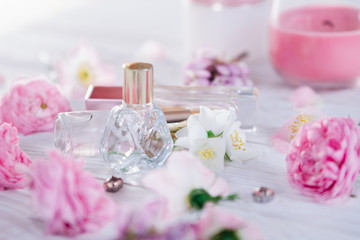 Obraz na płótnie Canvas Bottles of perfume with flowers