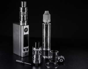 vape e liquid and vaping device for electronic cigarette on a dark background