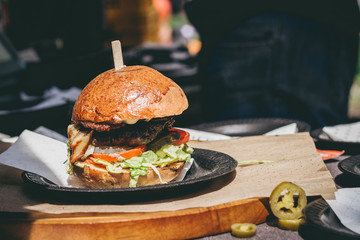 Fresh tasty grilled meat burger on the table. Selective focus
