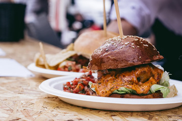 Fresh tasty grilled meat burger with sauce and cheddar on the table. Selective focus