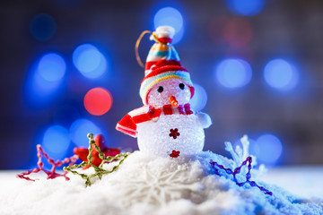 Christmas decorations in snow with blue backlight.