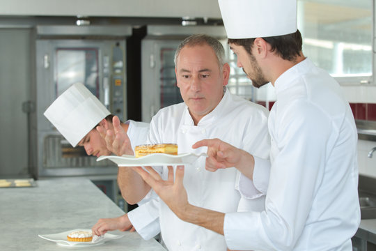 Trainee chef talking to his superior