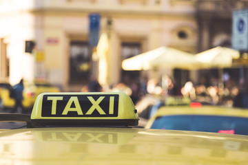 Taxi cars are waiting in row on the street in Prague. European tourism and travel concept. Selective focus image