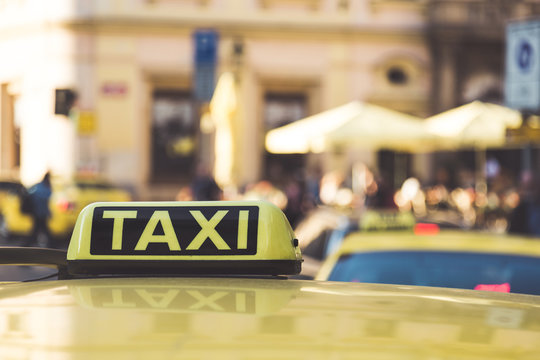 Taxi cars are waiting in row on the street in Prague. European tourism and travel concept. Selective focus image