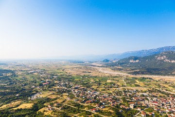 View of the red roofs of the Kalambaka town from the Meteora rocks, Greece.Red roofs of Kalambaka town from Meteora rocks, Greece.
