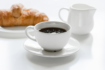 Businessman morning with cup of coffee and croussant on white table background