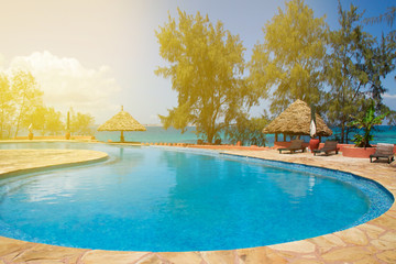 pool chairs under umbrellas. the concept of the journey