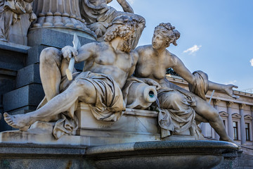 Naklejka premium Fragments of the Pallas Athena (goddess of wisdom) fountain, in front of the Austrian Parliament Building. The figures symbolize the rivers Danube, Inn, Elbe and Moldau. Vienna, Austria, Europe.
