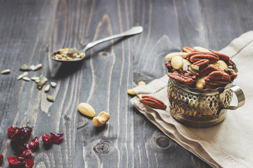 Nuts mix with seeds and dried fruits. Cashews, almonds and pecans on the wooden table
