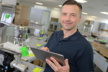 Portrait of retailer with tablet