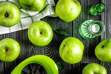 Organic fruits with green apples pattern on dark background top view