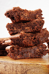 Brownie stack, chocolate cake on rustic wooden board