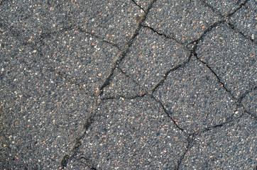 Asphalt texture with cracks. The texture of asphalt strongly cracked over time