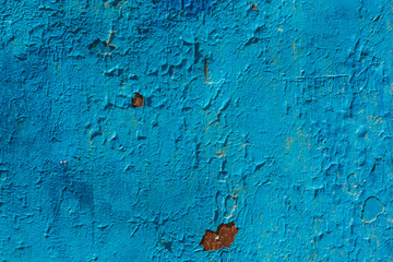 Old cracked bright blue paint background texture.