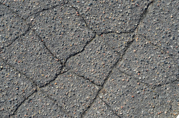 Asphalt texture with cracks. The texture of asphalt strongly cracked over time